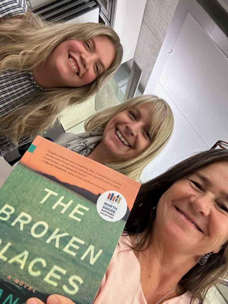 Left to right: North Shore authors Théodora Armstrong, Frances Peck, and Tara McGuire. Tara is holding a copy of The Broken Places that has a North Shore Authors Collection sticker on the cover.