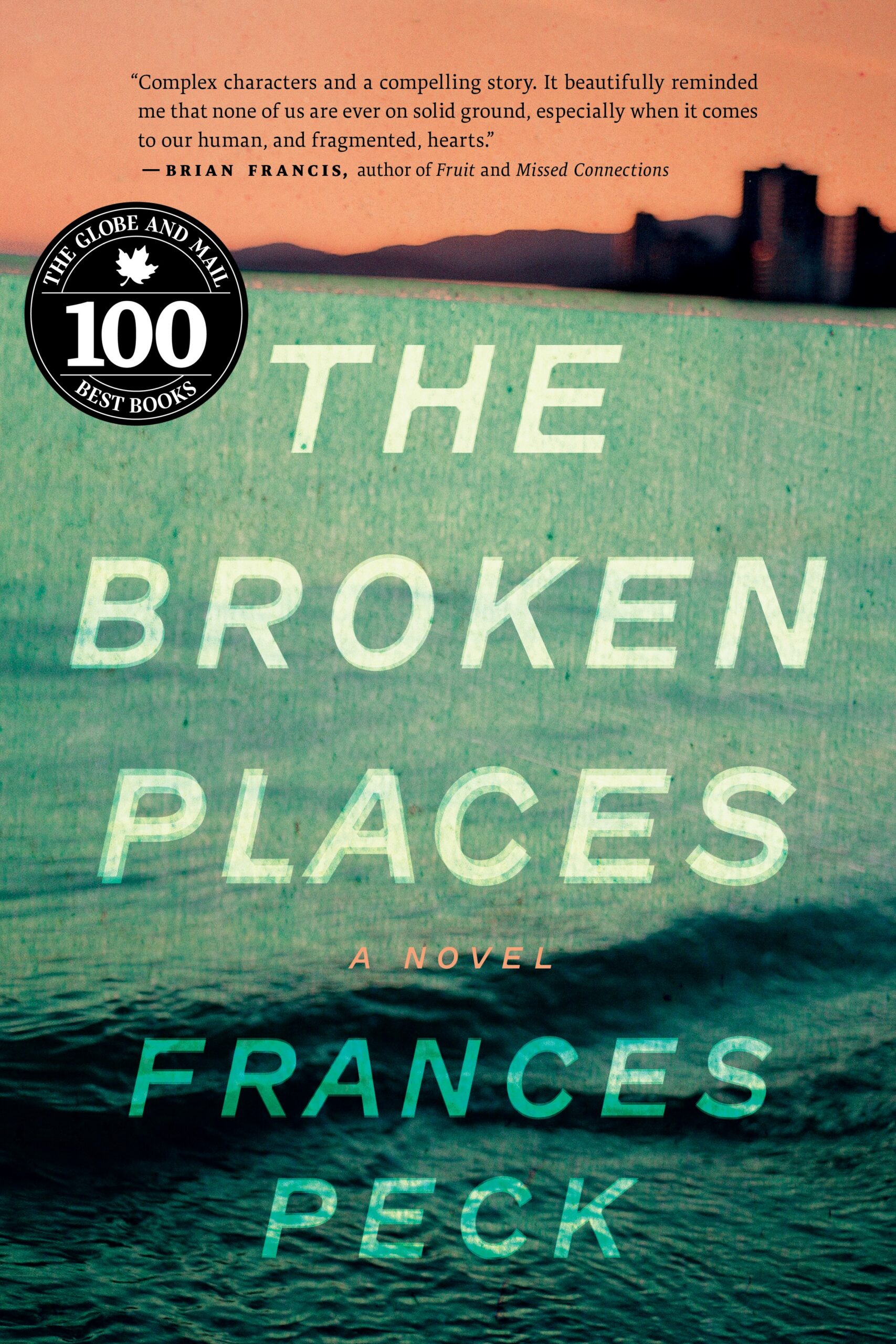 Cover of The Broken Places, with green harbour waves in the foreground and the West Vancouver skyline in background, silhouetted against peach background. Globe 100 Best Books sticker on left-hand side.