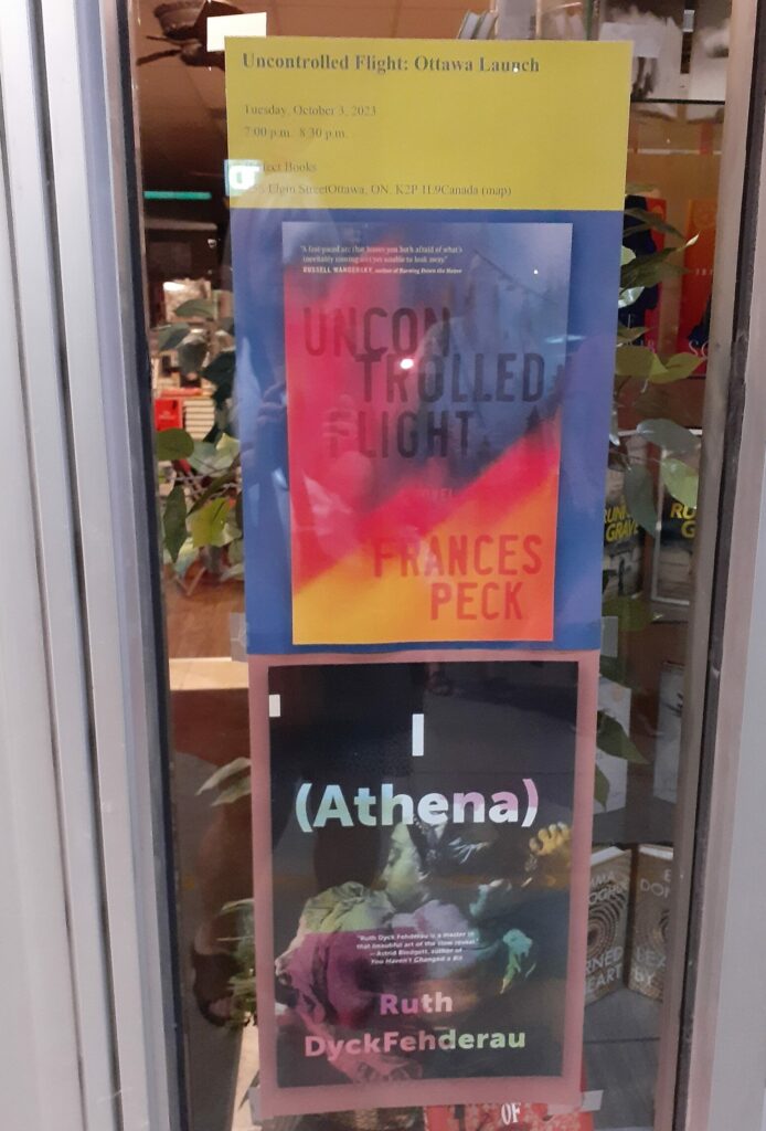 Poster of book covers for Uncontrolled Flight on the top and I (Athena) on the bottom in window of Perfect Books, Ottawa.