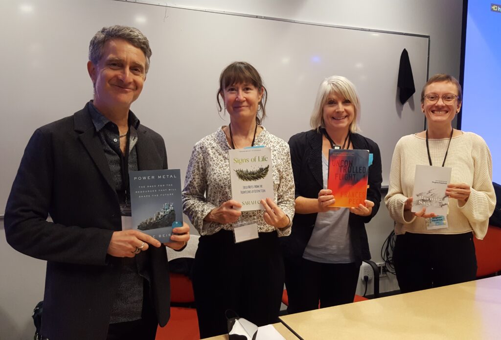 Authors on Environmental Concerns panel, standing side by side in the panel room and holding their books. Left to right, Vince Beiser with Power Metal, Sarah Cox with Signs of Life, Frances Peck with Uncontrolled Flight, and Meghan Fandrich with Burning Sage.